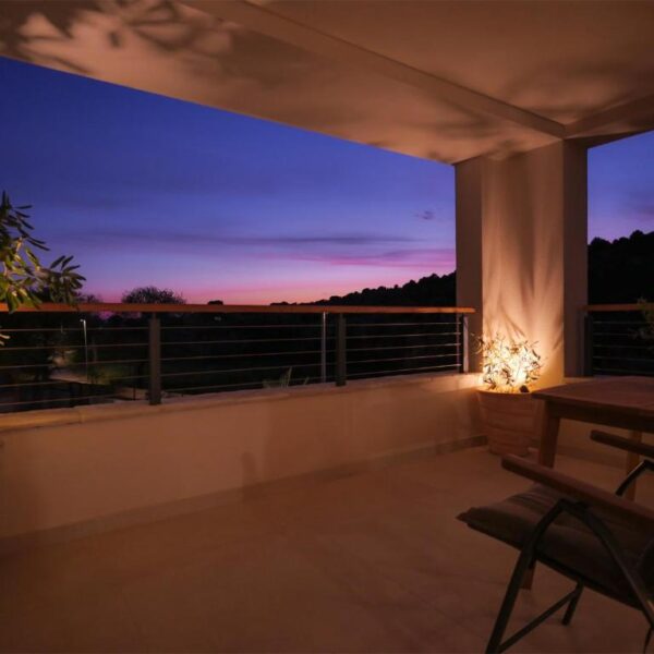 Illuminated balcony with a comfortable lounge
