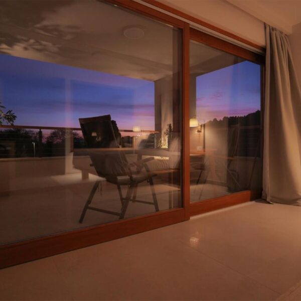 Evening view of spacious terrace with big patio doors from the room