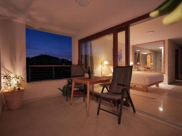 Evening view of the outside balcony lounge and room from balcony