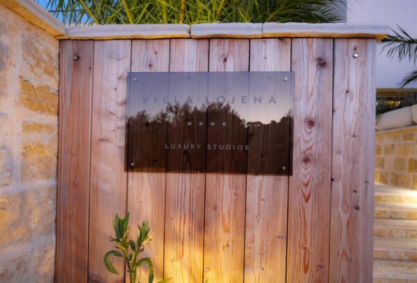entrance to the villa with glass sign