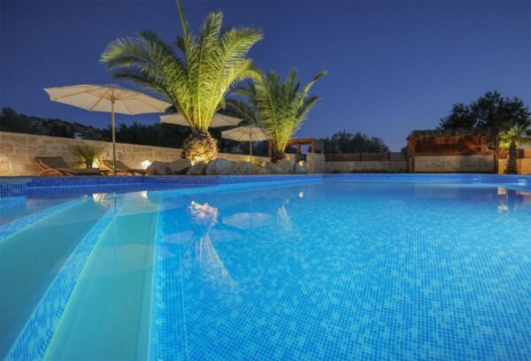 Evening view of pool and palms