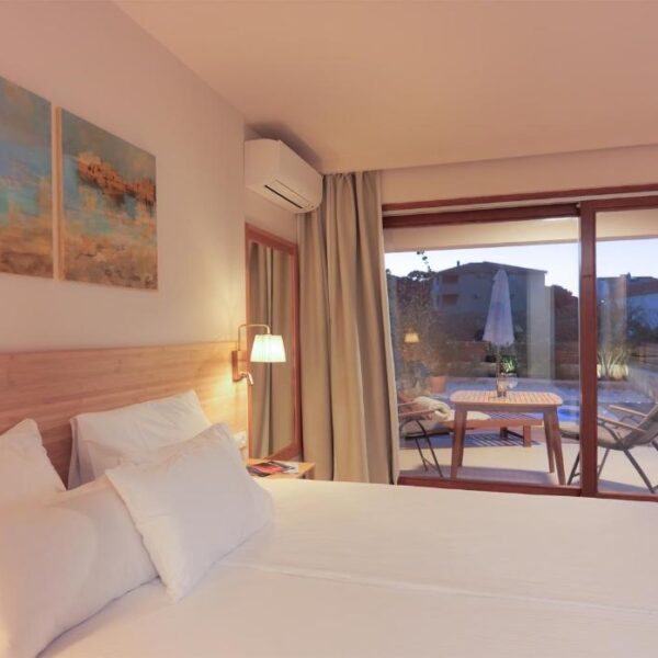 Premium studios double bed covered with white sheets