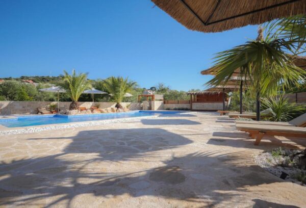 Sun covered terrace with view of the pool