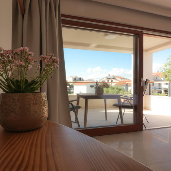 View of the sun covered terrace from the apartment