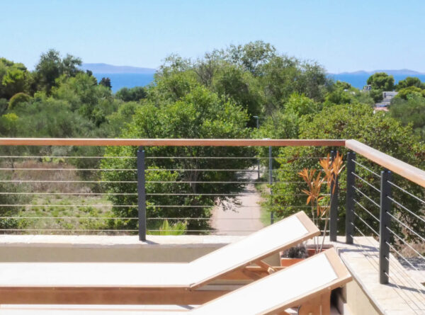 Sunny balcony with sun loungers and a view of the treetop path
