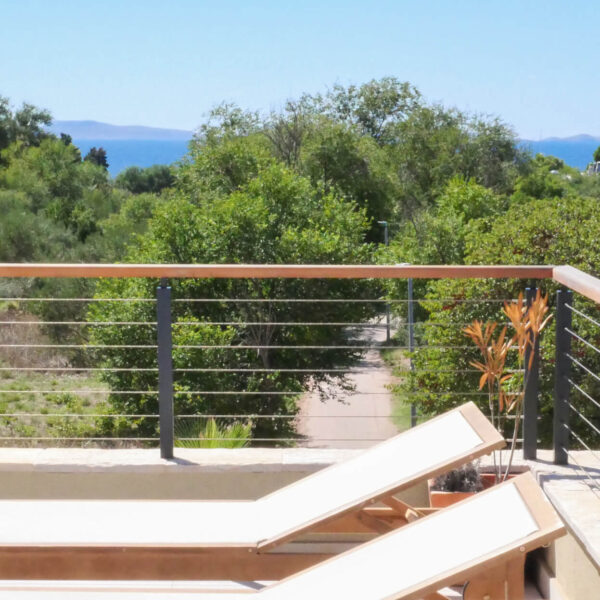 Sunny balcony with sun loungers and a view of the treetop path