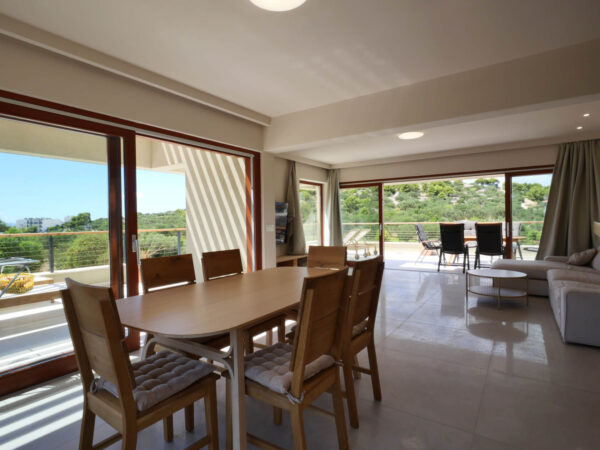 Bright and spacious living room with dining table and sofa
